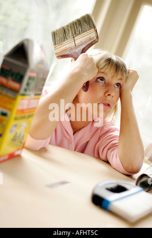 woman with paint brush fed up of decorating Stock Photo