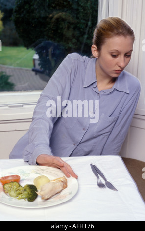 teenage girl pushing away food Stock Photo