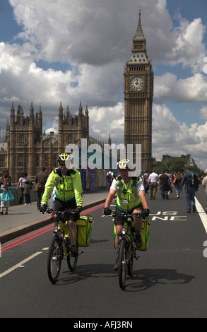 St John's Ambulance paramedics on bikes crossing Westminster Bridge by big ben  during closure for Tour de France 2007 Stock Photo