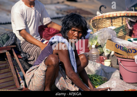 Man scavenging in street market Manila Philippines Stock Photo