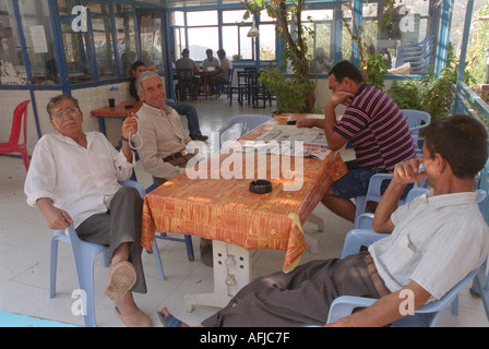 Older men sitting inside cafe bar in small rural village in South Western Turkey Stock Photo
