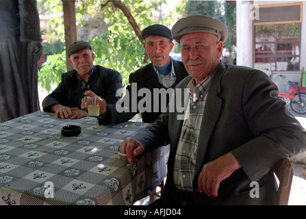 Older men sitting in the market square in town of Mulga in the Southwest of Turkey. Stock Photo