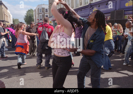 People dancing in the streets at the annual Notting Hill gate Carnival. Stock Photo
