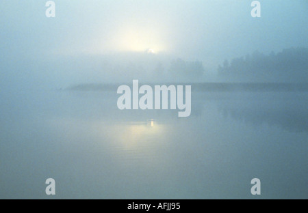 Misty sunrise on the lake Stock Photo