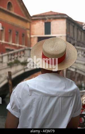 Gondolier wearing signature straw hat Venice Italy Stock Photo