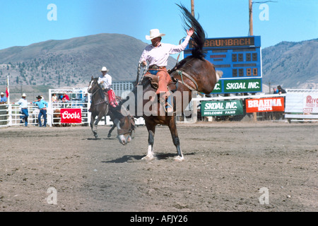 Saddle Bronc Riding at the Chopaka Rodeo in the Town of Cawston in the Similkameen Valley in British Columbia Canada Stock Photo