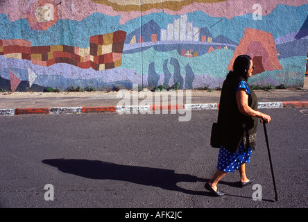 Pedestrian walks past a painted wall in Tiberias Israel Stock Photo