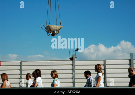 Pedestrians walk past a construction site in Lisbon Portugal Stock Photo