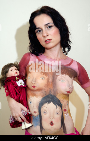 Body art female model with porcelain dolls