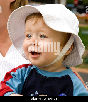 Portrait of happy baby boy wearing sunhat Stock Photo