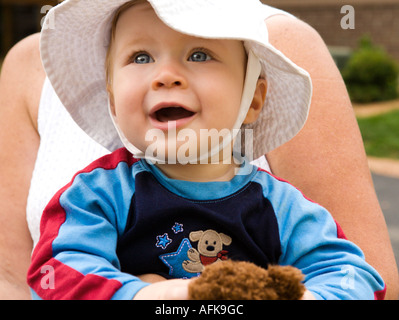 Happy baby boy on moms lap Stock Photo