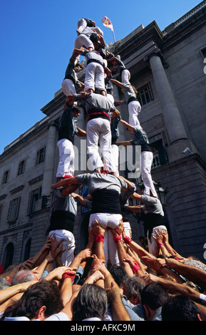 A castell (human castle) nears completion as the last performers scramble to the top, during the festival of La Merce. Stock Photo