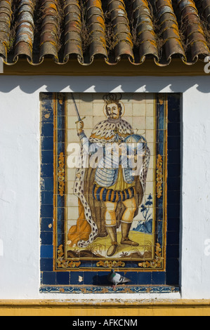 Mural of one of the historic Spanish kings made from painted ceramic tiles, adorns the wall of a house in the Santa Cruz area Stock Photo