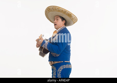 Portrait of Mariachi playing guitar and singing Stock Photo