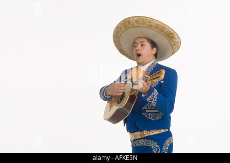 Portrait of Mariachi playing guitar and singing Stock Photo