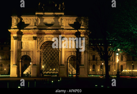 The Louvre Pyramid seen through the Arc de Triomphe du Carrousel at night, Paris, France. Stock Photo