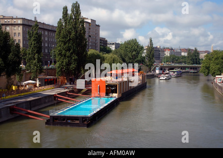 The Badeschiff or Bathing Ship a swimming pool built into a barge floating on the Danube Canal, Vienna, Austria Stock Photo