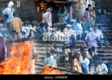Crowds at a funeral pyre on the banks of the Ganges Varanasi India Stock Photo