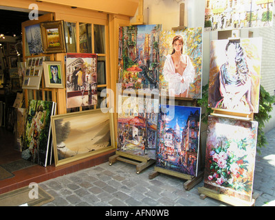 Display of paintings outside gallery shop near Place du Tertre Montmartre Paris France Stock Photo