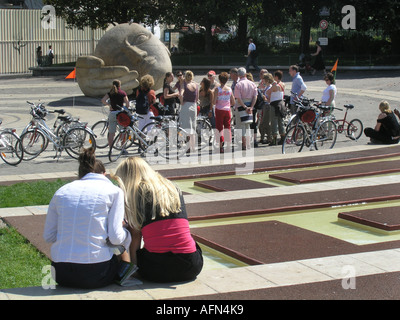 tourists doing a cycling trip through Paris taking a break at Jardin du Forum des  Halles Paris France Stock Photo