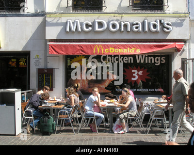 Adolescent teenagers taking a break at Mc Donalds fast food restaurant in Rue Berger Paris France Stock Photo