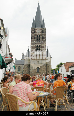 Wijngaard square with gothic church and tourists having a drink at terrace of roadside cafe Thorn Limburg Netherlands Stock Photo