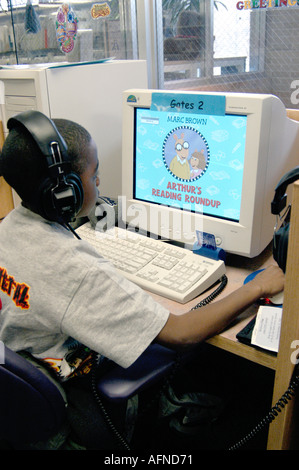 Black boy working at a computer on reading in a public library Stock Photo