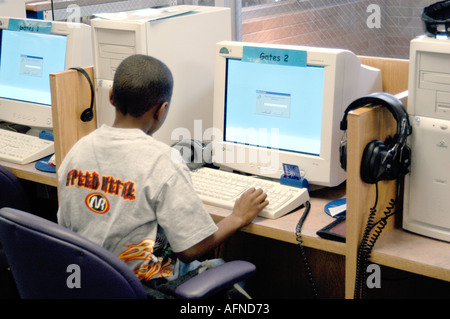 Black boy working at a computer on reading in a public library Stock Photo