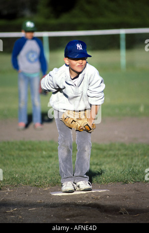 Baseball Softball Action Little league batter hits ball Stock Photo - Alamy