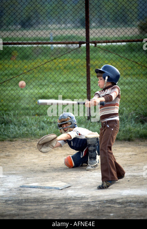 Baseball Softball Action Little league batter hits ball Stock Photo