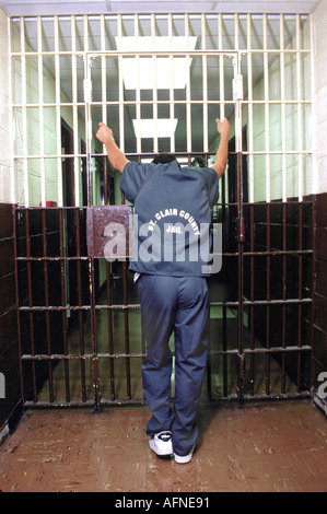 Teen male sits in jail after being sentenced for a crime Stock Photo