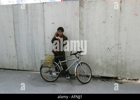 A cyclist calls on his mobile Stock Photo