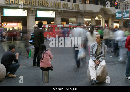 Shoppers on bollards Stock Photo