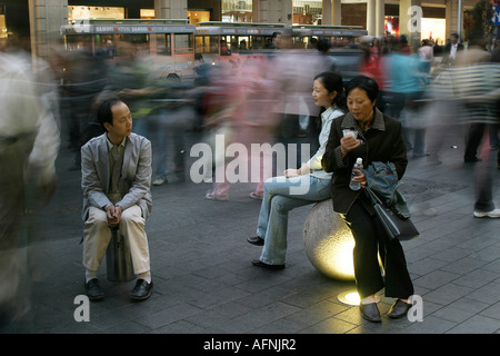 Shoppers on bollards Stock Photo