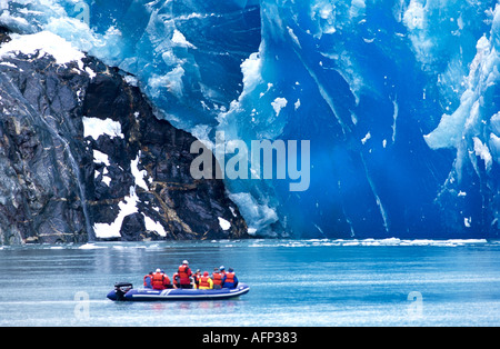 USA Alaska people in zodiac boat observing Sawyer Glacier Tracie Arm in Southeast Alaska Stock Photo
