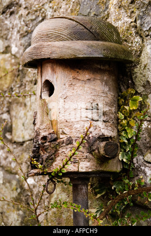 Unusual wooden bird nesting box made from a log Stock Photo