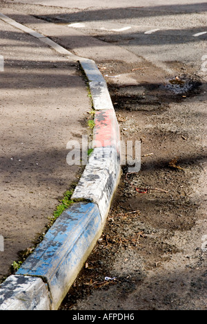 Peeling red white and blue kerb stones in Northern Ireland a fading reminder of sectarian differences Stock Photo
