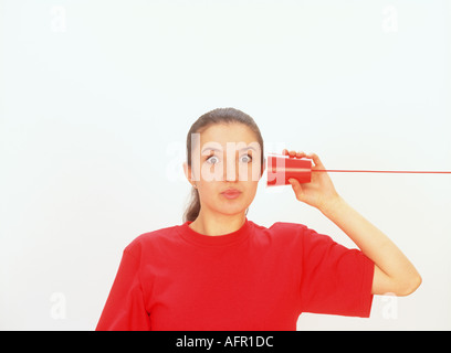 Western Woman Listening on String Telephone Stock Photo - Alamy