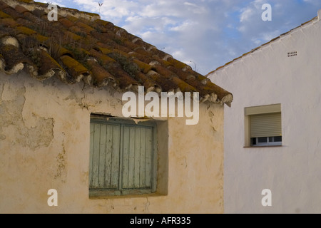 The contrast between old original wall and window and the modern version in the white village of Casares in Andalucia Spain Stock Photo