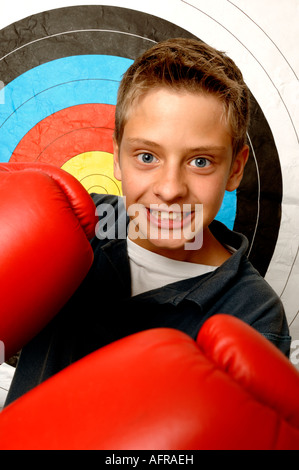 Boy wearing red boxing gloves Stock Photo