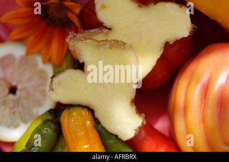 Close up of fresh pineapple slices with red flowers and chillies Stock Photo