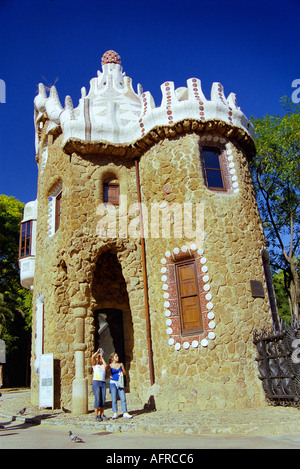 Tourists by the Ginger bread house just inside the entrance of Antoni Gaudís landscape park Parc Güell in Barcelona Spain Stock Photo