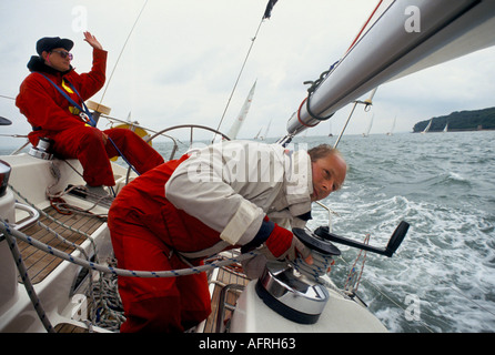 Waterproof clothing. Sailing racing yacht UK Crew in The Round the Island Race race the Isle of Wight England 1980s HOMER SYKES Stock Photo