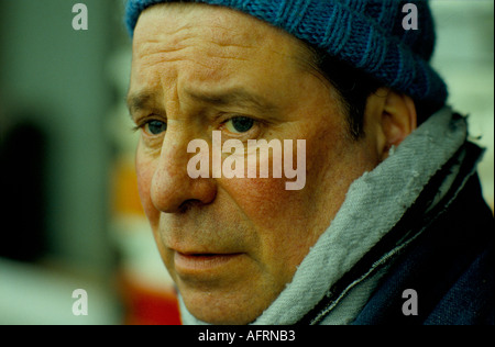 Man looking sad cold and wearing a home made wooly knitted hat a dock worker at Albert Docks. 1980s 1980s UK HOMER SYKES Stock Photo