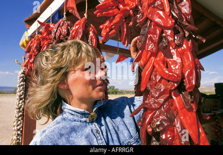 A string of redchile ristras at the Tiwa pueblo Taos located in Taos New Mexico at the base of the Sangre de Cristo Mountains Stock Photo