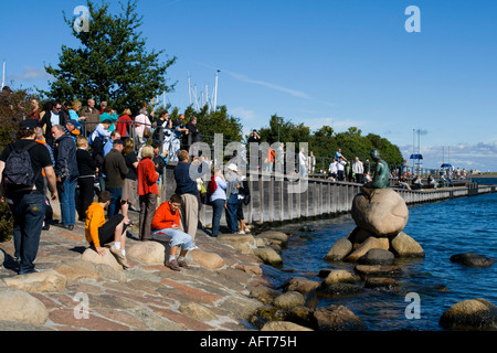 Tourists looking at the Little Mermaid in Copenhagen Denmark Stock Photo