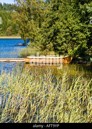 Rowing boat by a jetty in a lake Stock Photo - Alamy