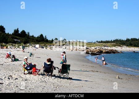 sunbathers on the sandy shore of Crystal Crescent Beach, Halifax, Nova Scotia, Canada. Photo by Willy Matheisl Stock Photo