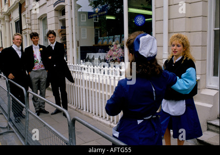 Rich poor social contrast 1990s UK. Eton public school boys and kitchen staff  taking photos of 6th formers. 1990 England HOMER SYKES Stock Photo