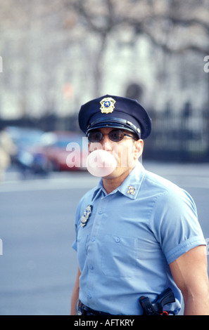Police officer blowing gum Stock Photo - Alamy
